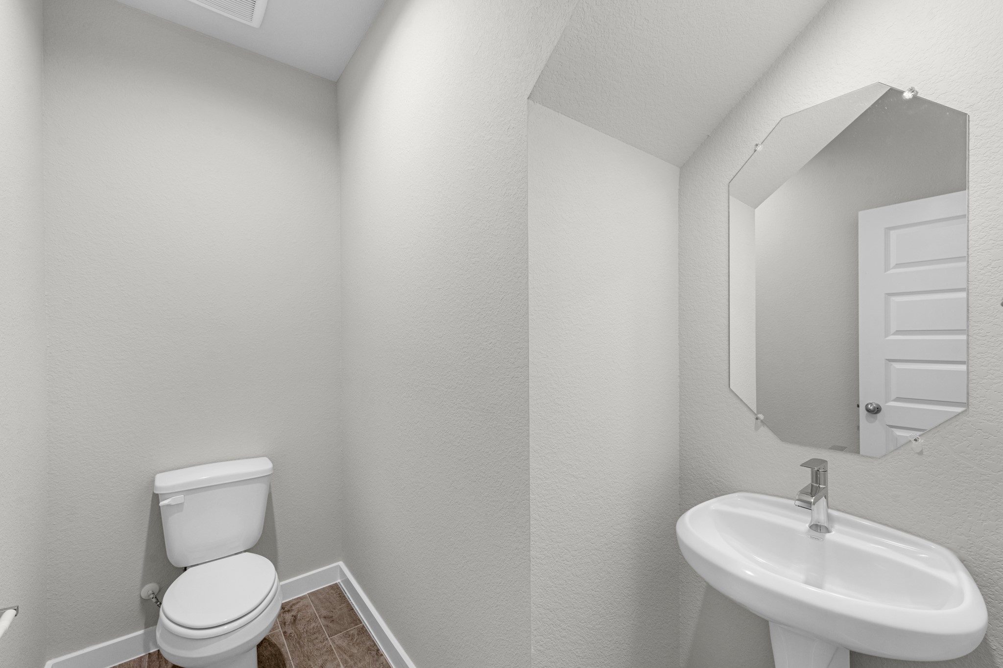 3107 Spitfire Drive Rosenberg, TX 77471 - Photo 17 of 39 a white toilet sitting next to a bathroom sink