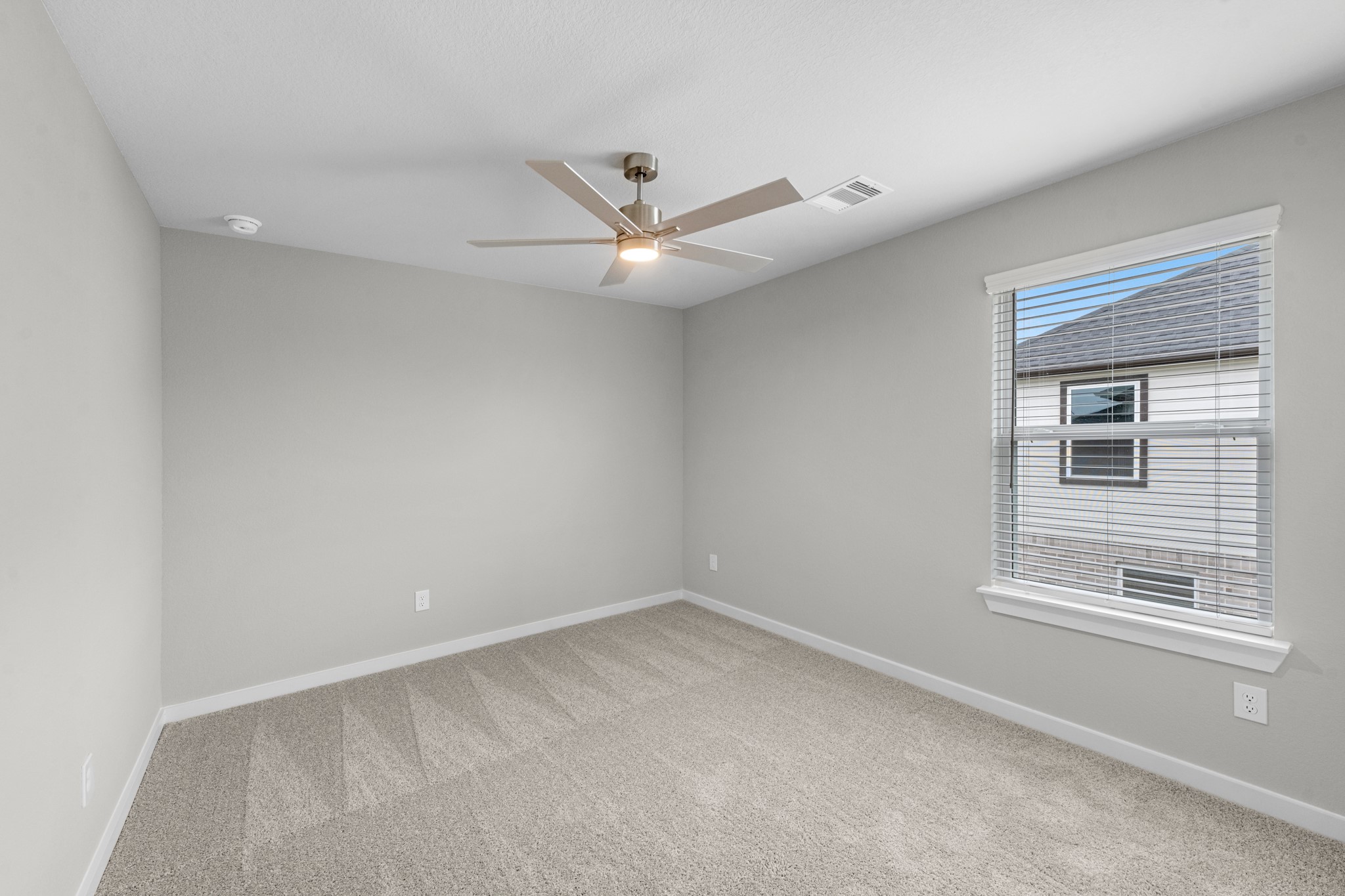 3107 Spitfire Drive Rosenberg, TX 77471 - Photo 21 of 39 an empty room with a window and a ceiling fan
