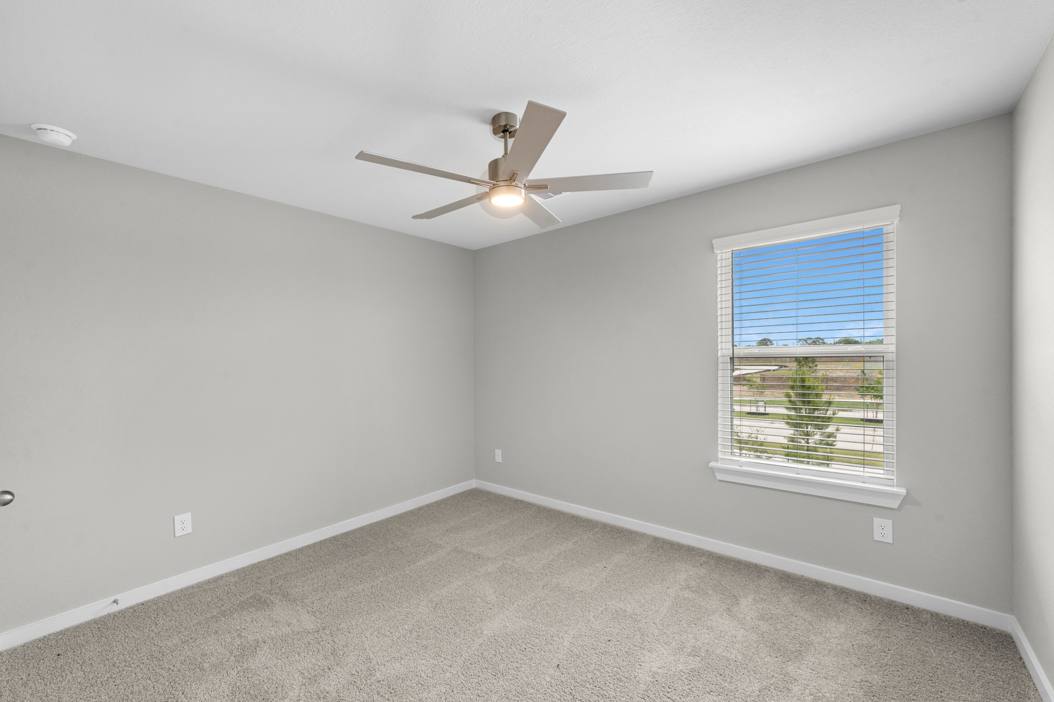 3107 Spitfire Drive Rosenberg, TX 77471 - Photo 24 of 39 an empty room with a window and a ceiling fan