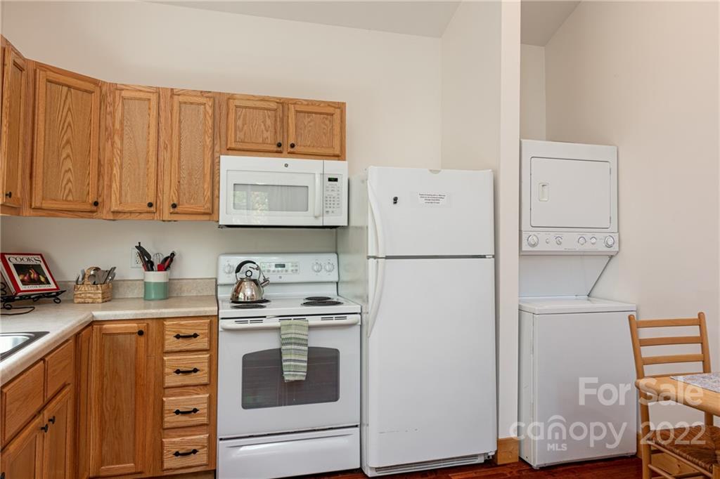 29 Davidson Road Asheville, NC 28803 - Photo 16 of 37 a kitchen with stainless steel appliances a refrigerator sink and cabinets