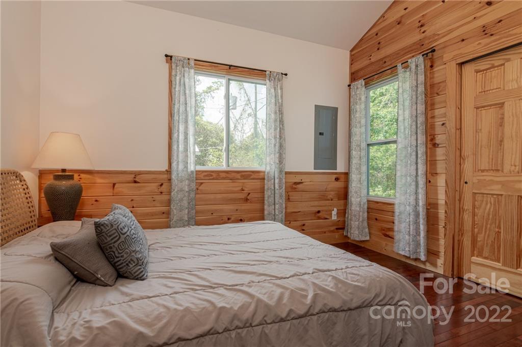 29 Davidson Road Asheville, NC 28803 - Photo 20 of 37 a bedroom with a bed and wooden floor
