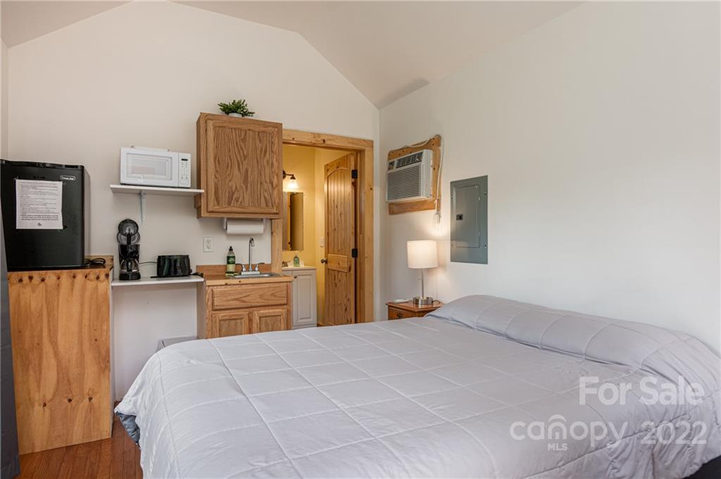 29 Davidson Road Asheville, NC 28803 - Photo 28 of 37 a bedroom with a bed and cabinets