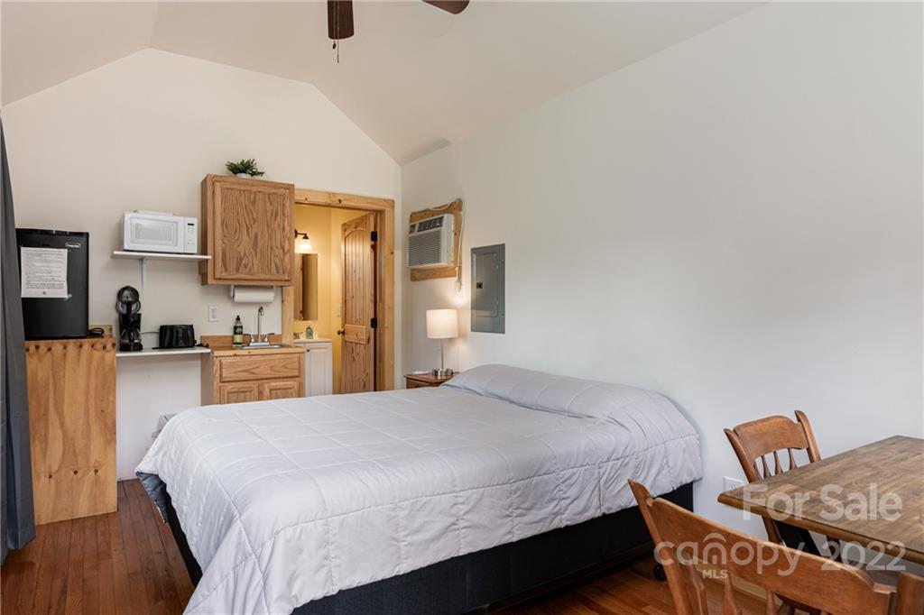 29 Davidson Road Asheville, NC 28803 - Photo 29 of 37 a bedroom with a bed and wooden floor