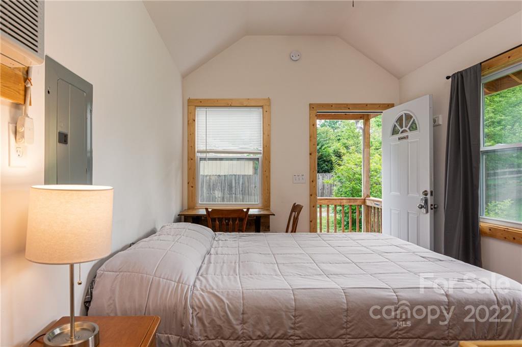 29 Davidson Road Asheville, NC 28803 - Photo 31 of 37 a bedroom with a bed and wooden floor