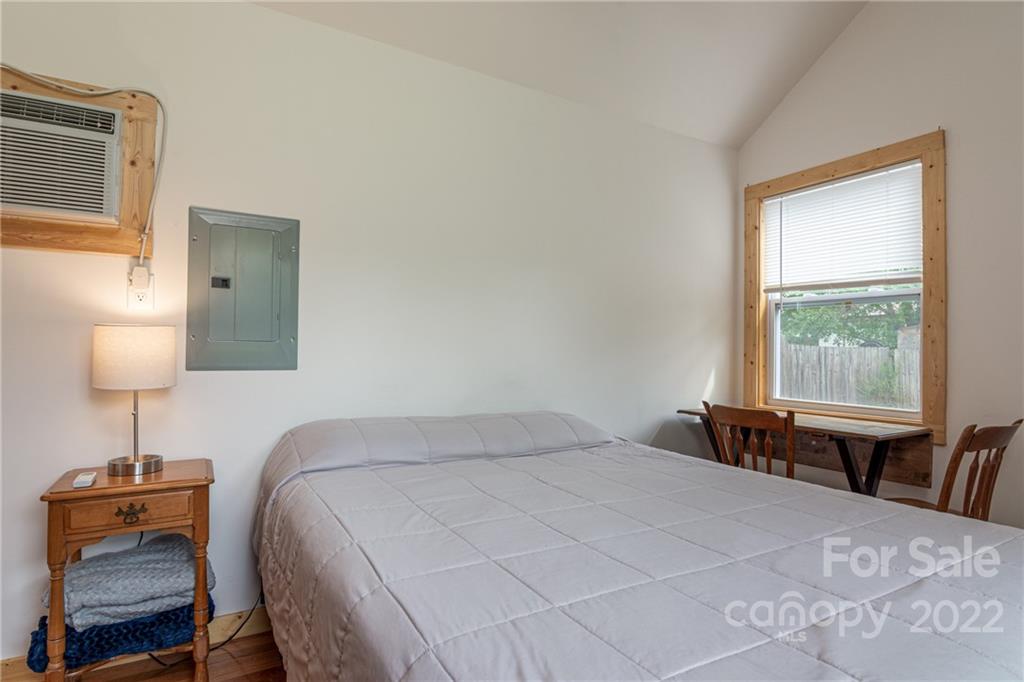 29 Davidson Road Asheville, NC 28803 - Photo 32 of 37 a bedroom with a bed and a lamp