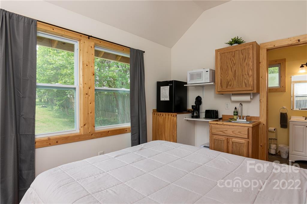 29 Davidson Road Asheville, NC 28803 - Photo 33 of 37 a bedroom with a bed and wooden floor