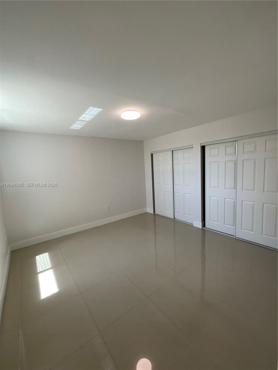 9441 Southwest 4th Street, Unit 214 Miami, FL 33174 - Photo 15 of 22 an empty room with a empty space and windows
