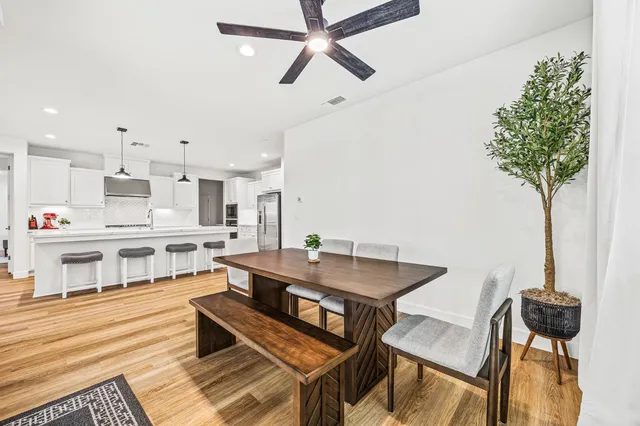 a view of a dining room with furniture and a potted plant