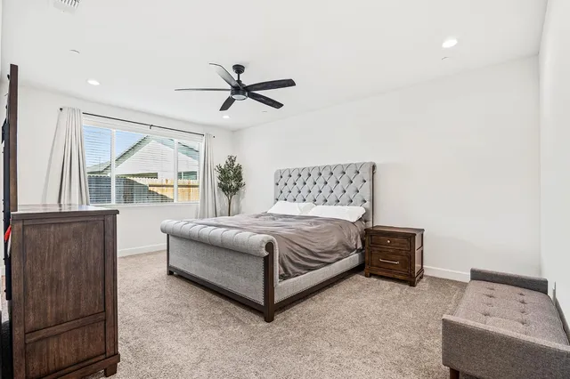 a bedroom with a bed window and couch