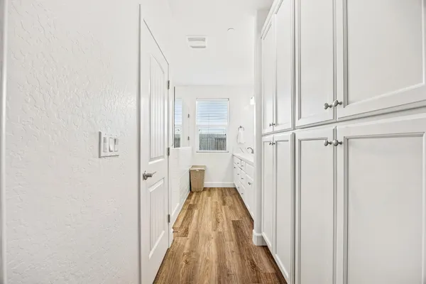 a view of a hallway with wooden floor and staircase
