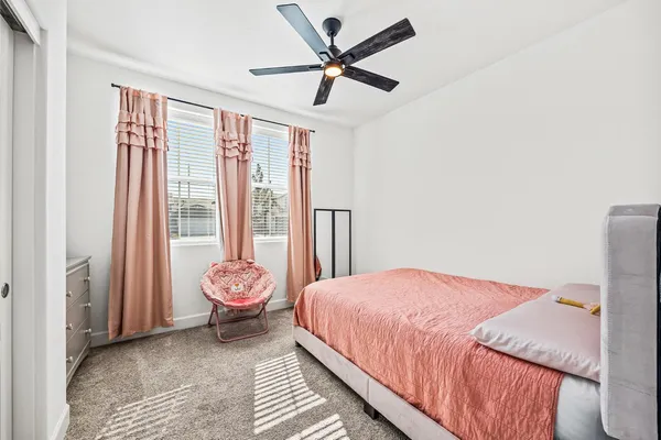 a bedroom with a bed and a large window