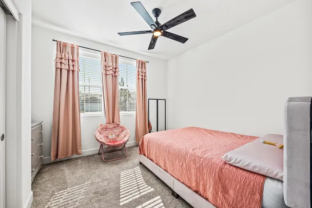 a bedroom with a bed and a large window