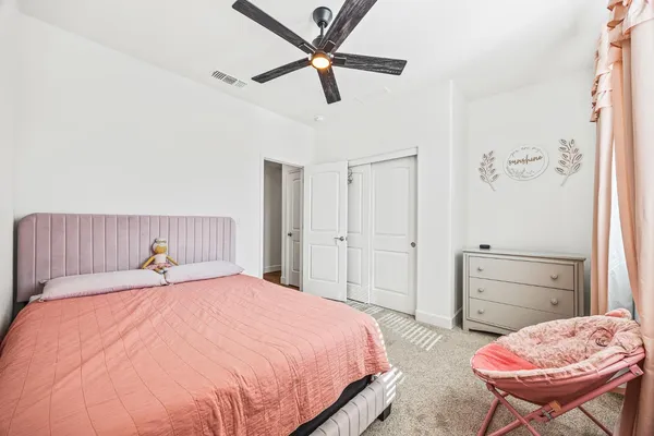 a bedroom with a bed and chair