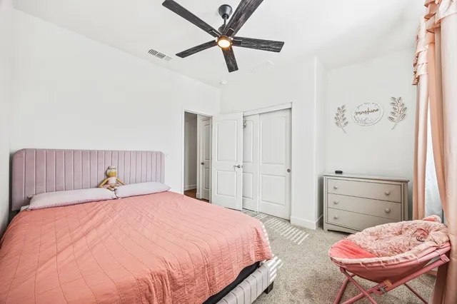 a bedroom with a bed and chair