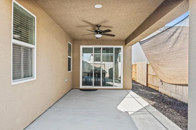 a view of a livingroom with wooden floor and a ceiling fan