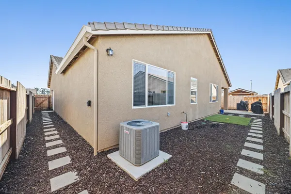 a front view of a house with wooden fence