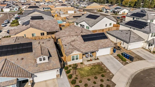 an aerial view of a house with backyard space