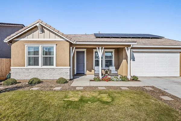 a front view of a house with a yard