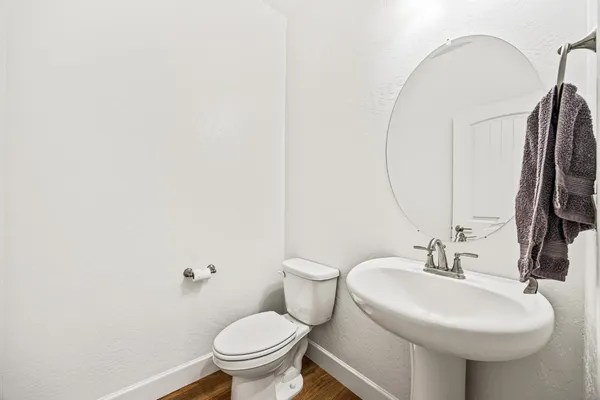 a bathroom with a sink toilet and a mirror