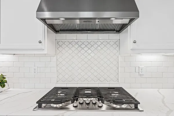 a stove top oven sitting inside of a kitchen