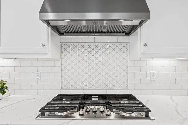 a stove top oven sitting inside of a kitchen