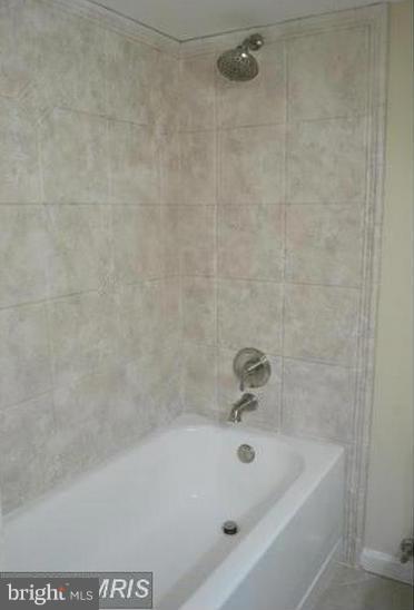 6022 Brunswick Street Springfield, VA 22150 - Photo 14 of 24 a bath tub sitting next to a white sink and a shower