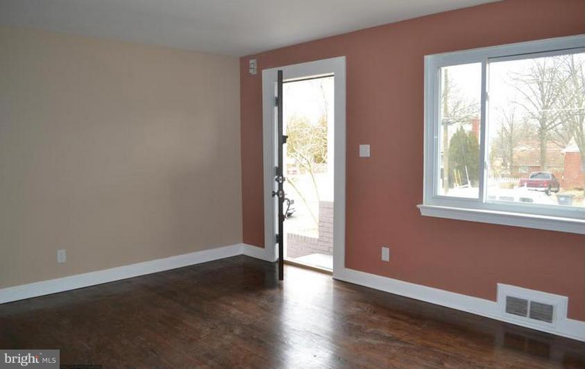 6022 Brunswick Street Springfield, VA 22150 - Photo 19 of 24 a view of an empty room with wooden floor and a window