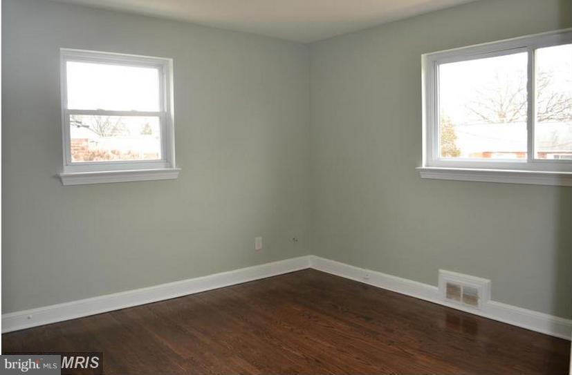 6022 Brunswick Street Springfield, VA 22150 - Photo 21 of 24 an empty room with wooden floor and windows
