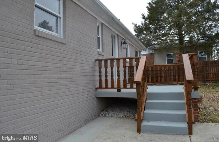6022 Brunswick Street Springfield, VA 22150 - Photo 4 of 24 a view of entryway with wooden stairs and a fire pit