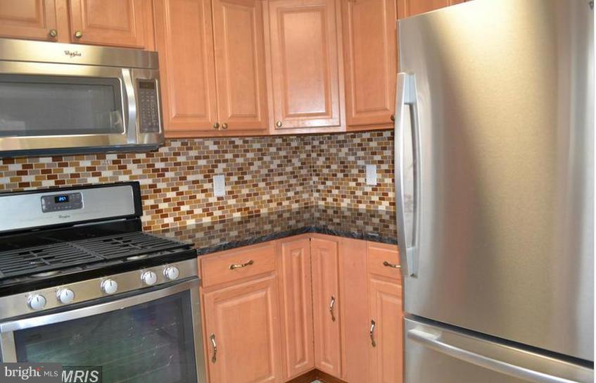 6022 Brunswick Street Springfield, VA 22150 - Photo 6 of 24 a kitchen with a stove and a microwave