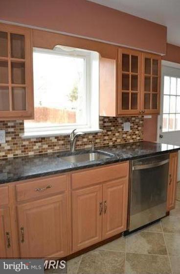 6022 Brunswick Street Springfield, VA 22150 - Photo 7 of 24 a kitchen with granite countertop a sink and white cabinets