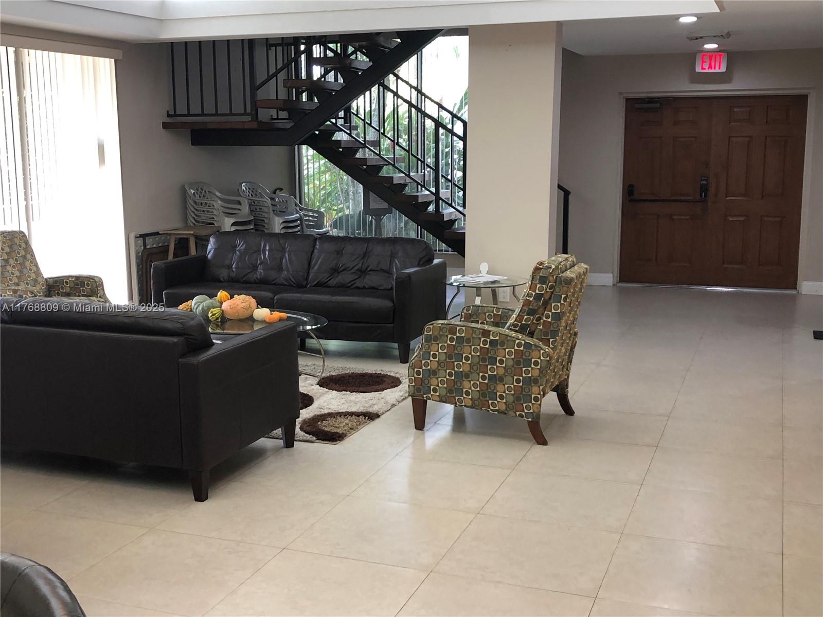 8589 Southwest 115th Place Miami, FL 33173 - Photo 12 of 13 a living room with furniture and a fireplace