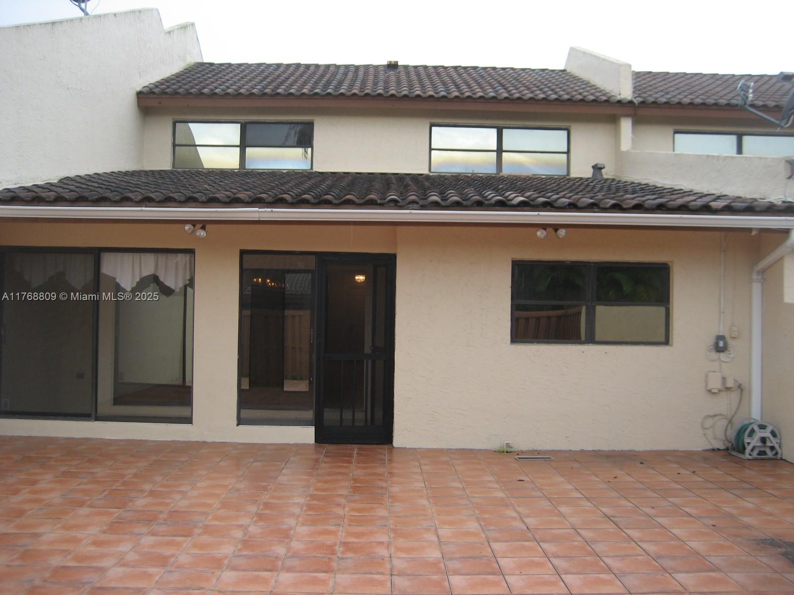8589 Southwest 115th Place Miami, FL 33173 - Photo 2 of 13 a front view of a house with yard
