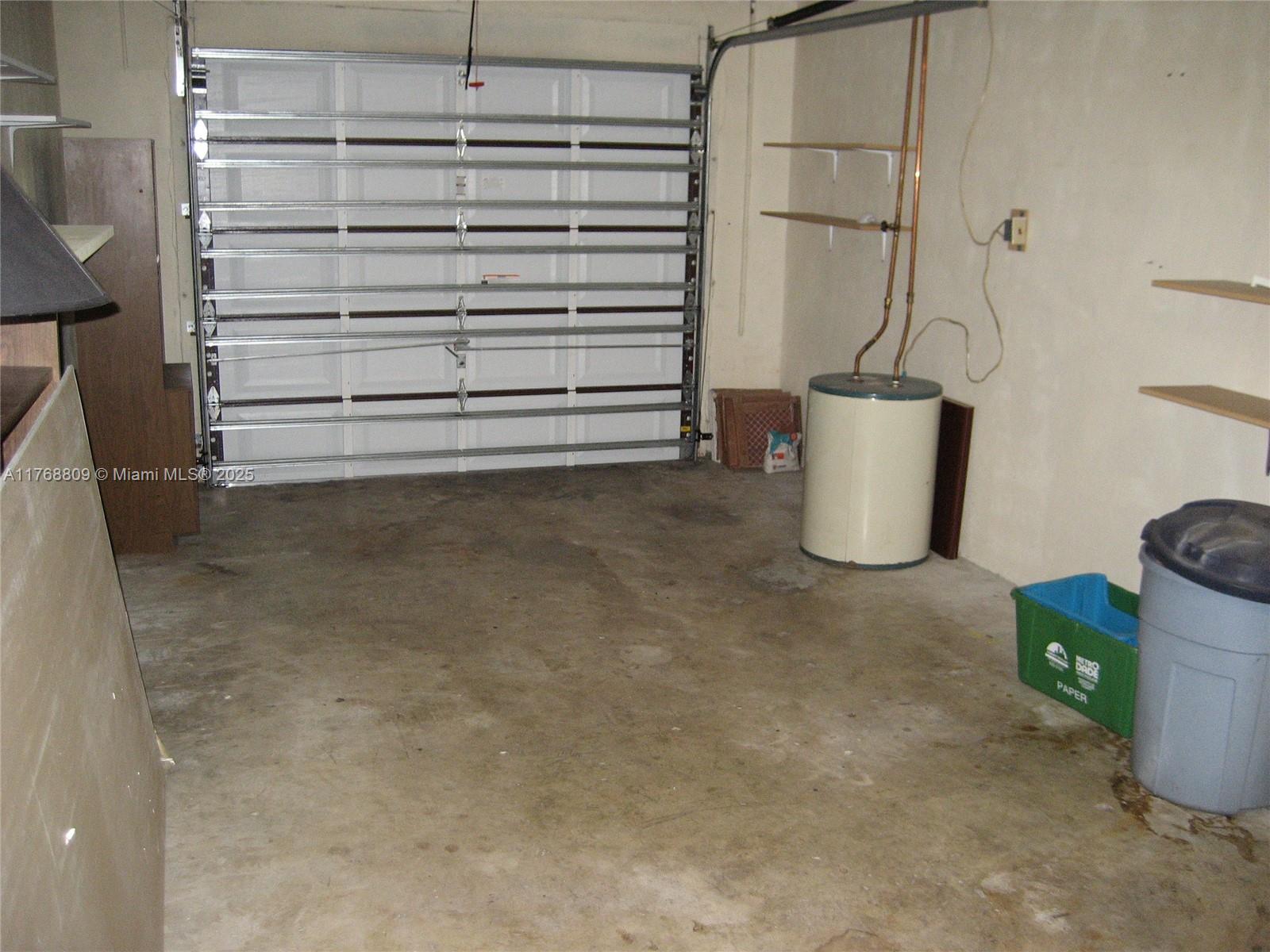 8589 Southwest 115th Place Miami, FL 33173 - Photo 4 of 13 a view of walk in closet with clothes and shoes