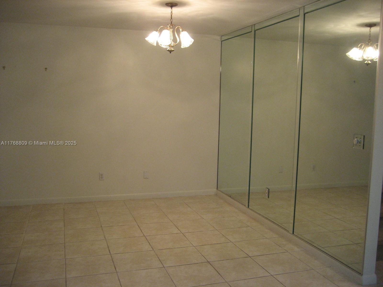 8589 Southwest 115th Place Miami, FL 33173 - Photo 5 of 13 a view of empty room with window
