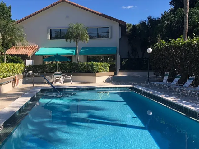 a view of house with a yard and sitting area