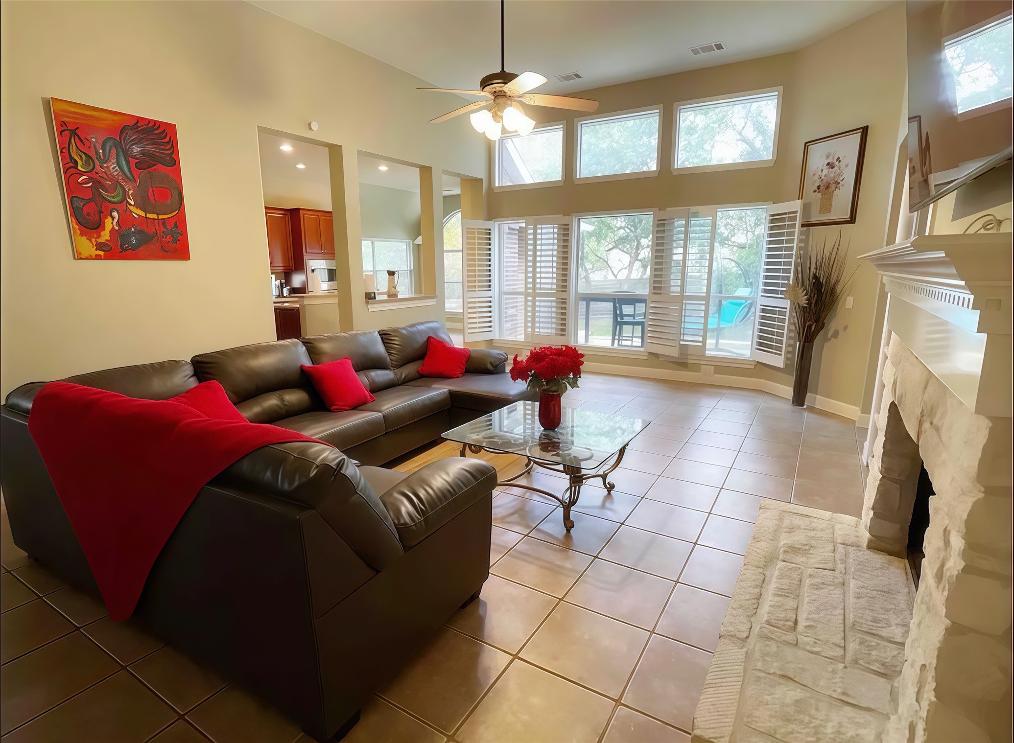 12616 Alberta Ridge Trail Austin, TX 78726 - Photo 2 of 26 A stone fireplace anchors this living space under soaring ceilings and transom windows.