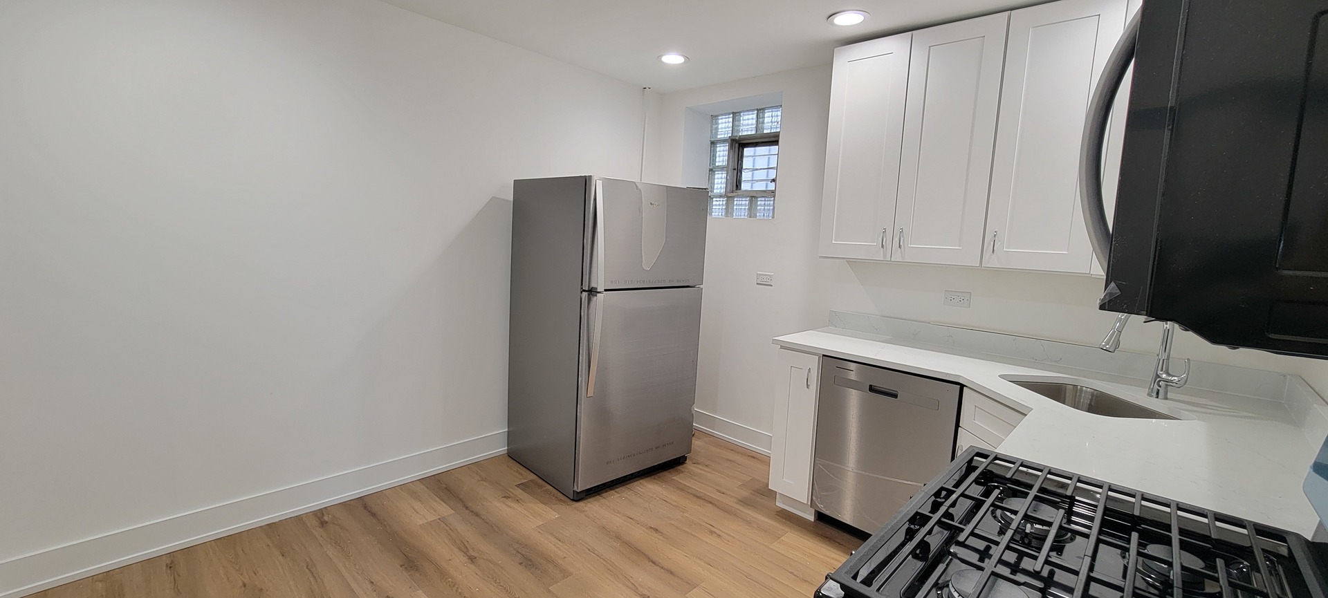3207 North Wilton Avenue, Unit 2 Chicago, IL 60657 - Photo 11 of 14 a kitchen with a refrigerator and a sink