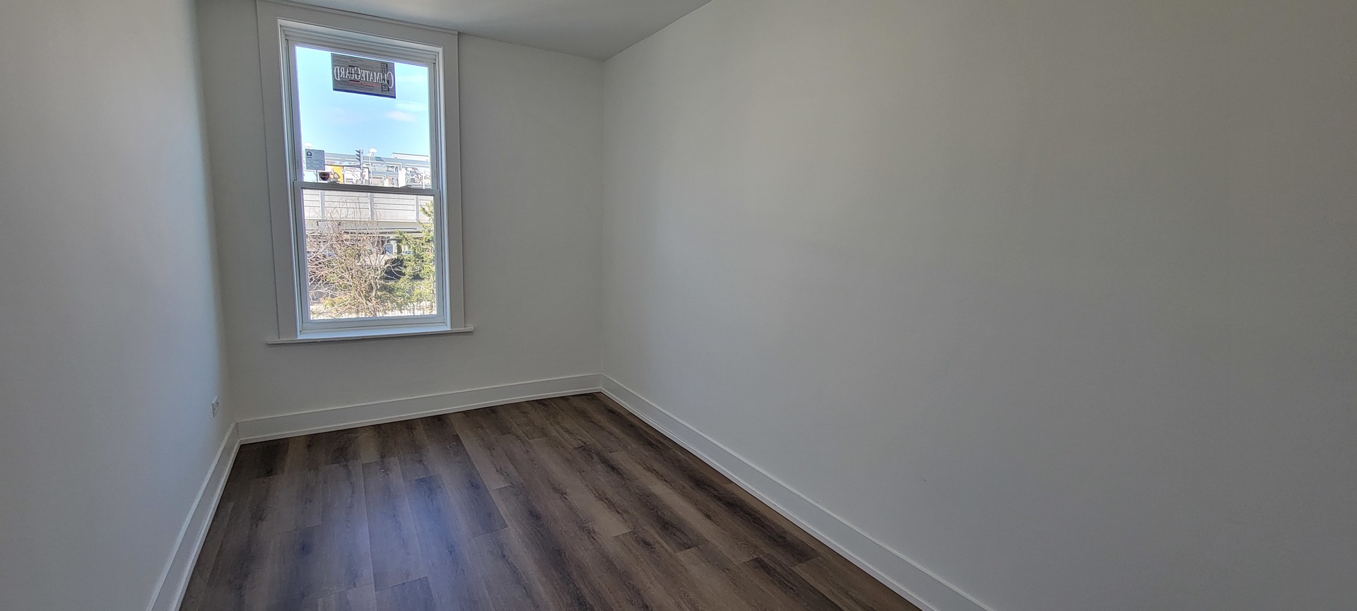 3207 North Wilton Avenue, Unit 2 Chicago, IL 60657 - Photo 5 of 14 a view of a small space with wooden floor and a window