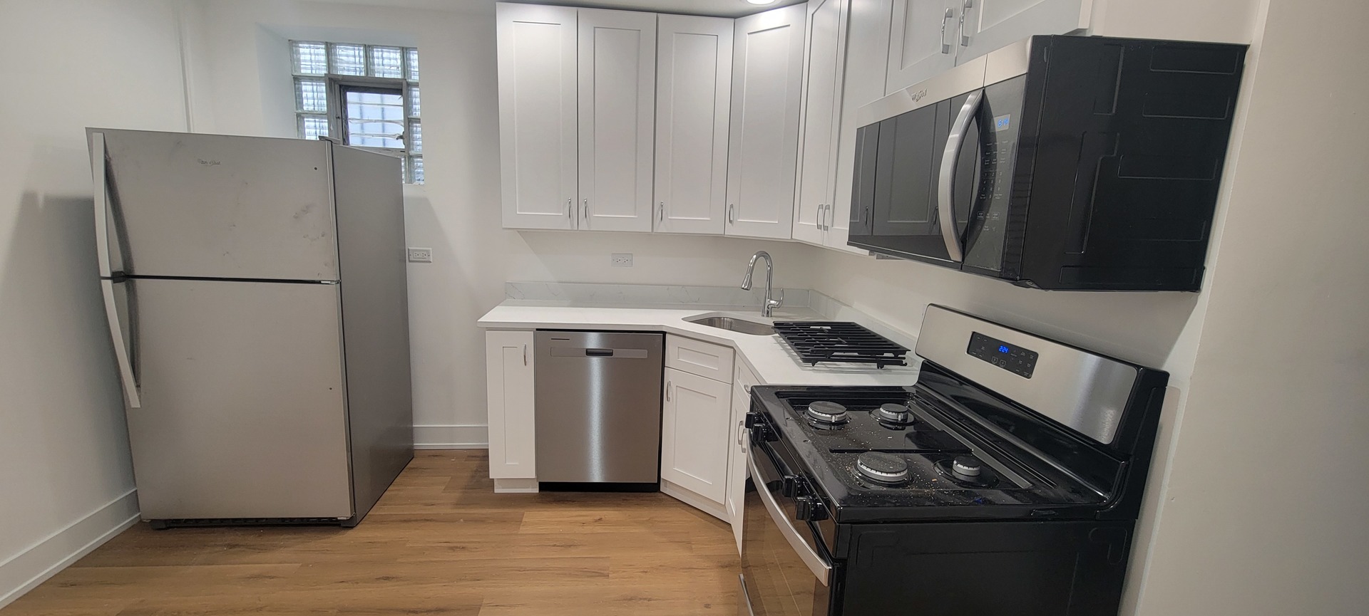 3207 North Wilton Avenue, Unit 2 Chicago, IL 60657 - Photo 8 of 14 a kitchen with a refrigerator sink stove and cabinets