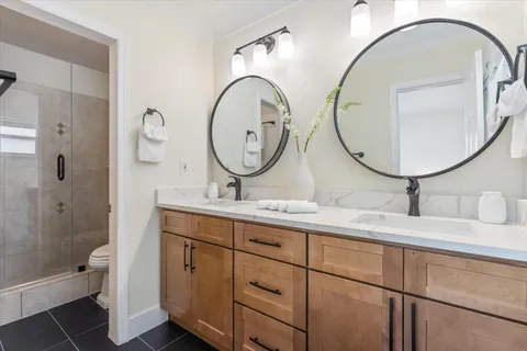 a bathroom with a toilet a sink and a mirror
