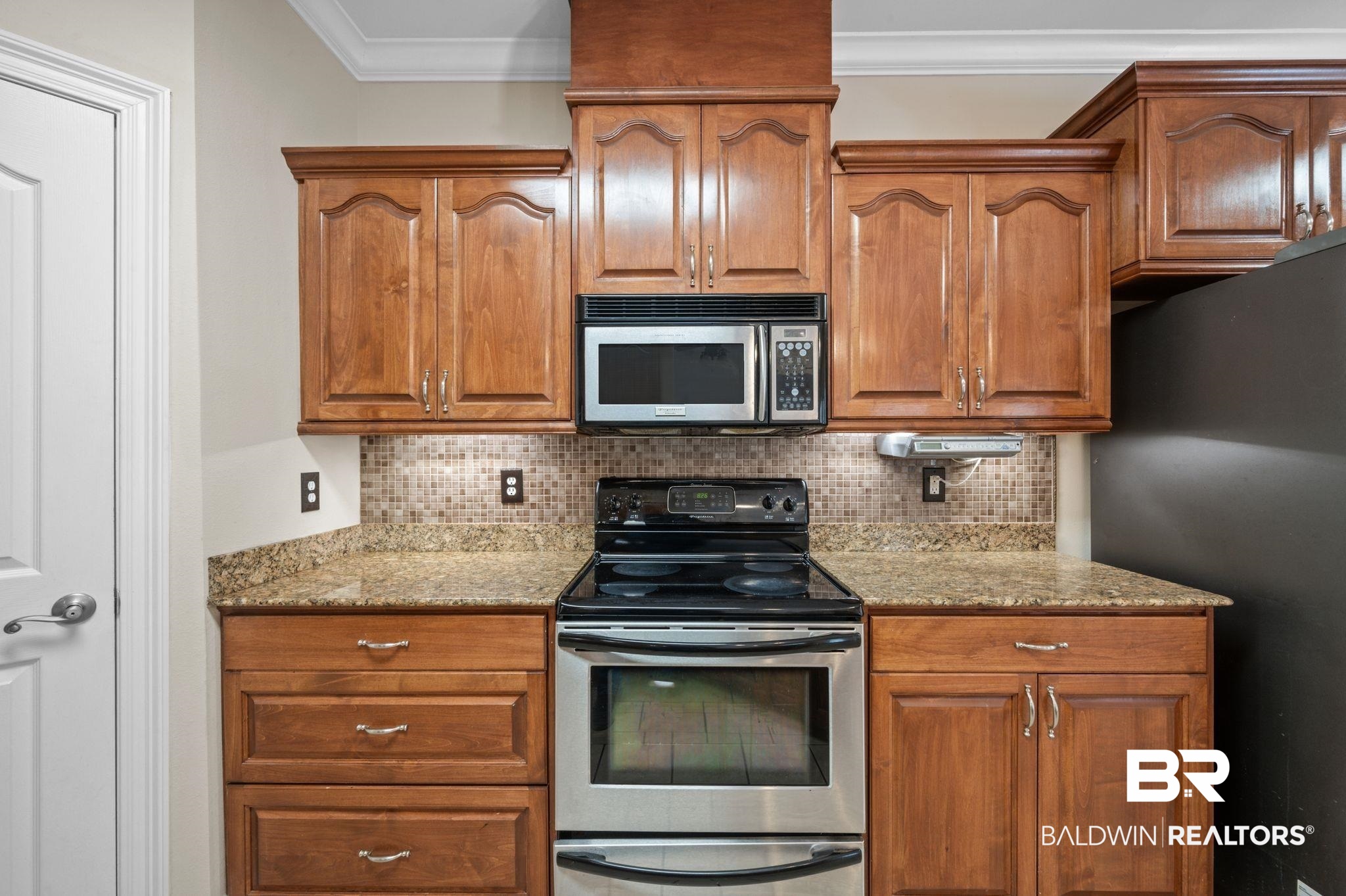 2041 Ridgeline Drive Mobile, AL 36695 - Photo 8 of 43 Kitchen with light stone countertops, stainless steel appliances, and backsplash