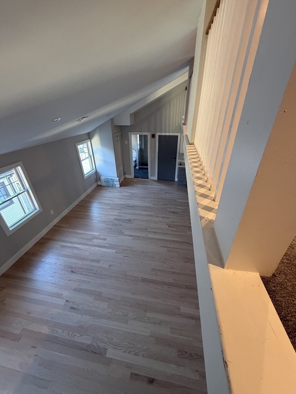 944 East Street, Unit 3 Walpole, MA 02081 - Photo 10 of 23 a view of a livingroom with wooden floor and stairs