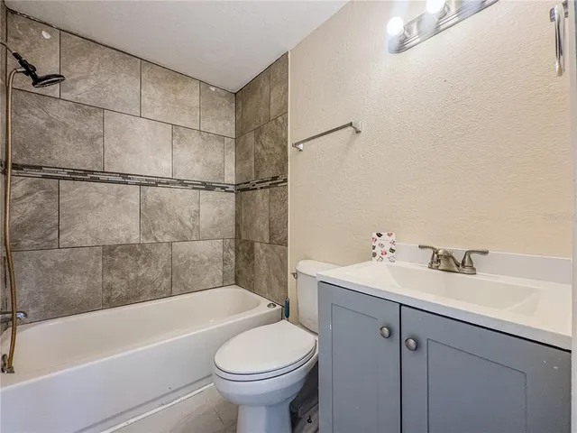 a bathroom with a sink toilet and bathtub