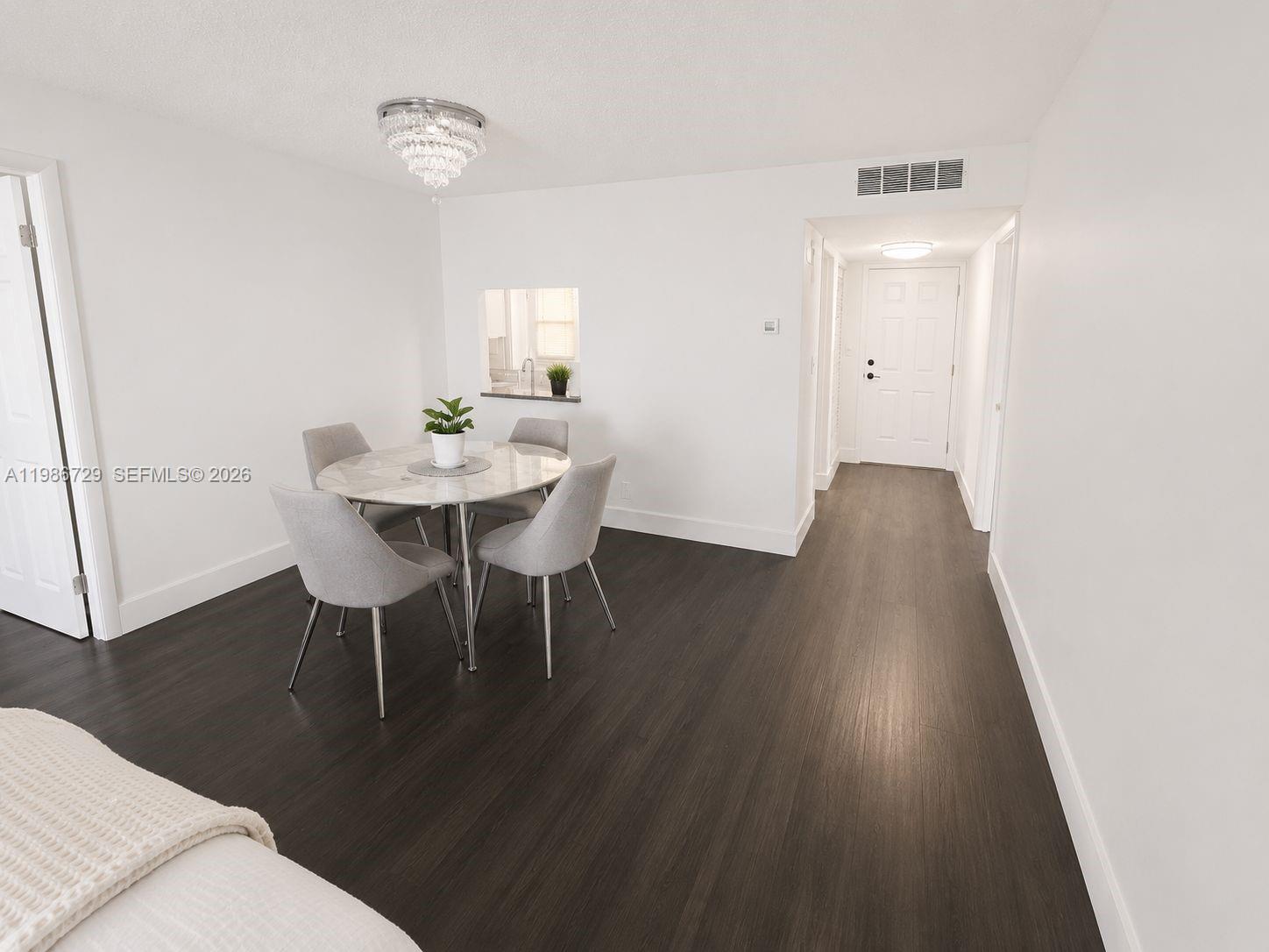 299 Northwest 52nd Terrace, Unit PHX Boca Raton, FL 33487 - Photo 11 of 16 a view of a dining room with furniture and wooden floor