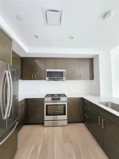 a kitchen with stainless steel appliances a stove and a sink