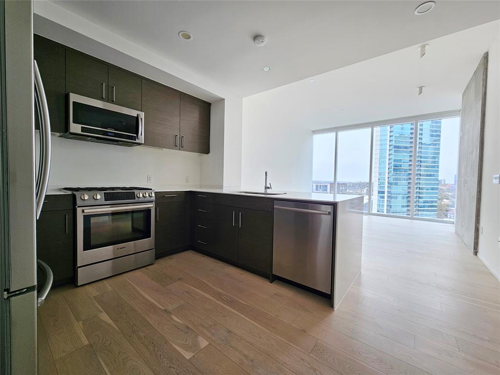 301 West Avenue, Unit 1603 Austin, TX 78701 - Photo 5 of 18 a kitchen with a stove and a microwave
