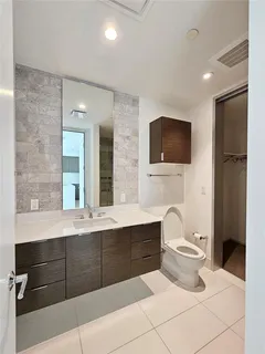 a bathroom with a sink a toilet and mirror