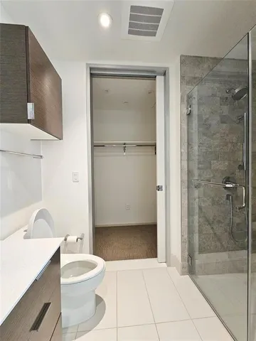 a bathroom with a toilet a sink and shower
