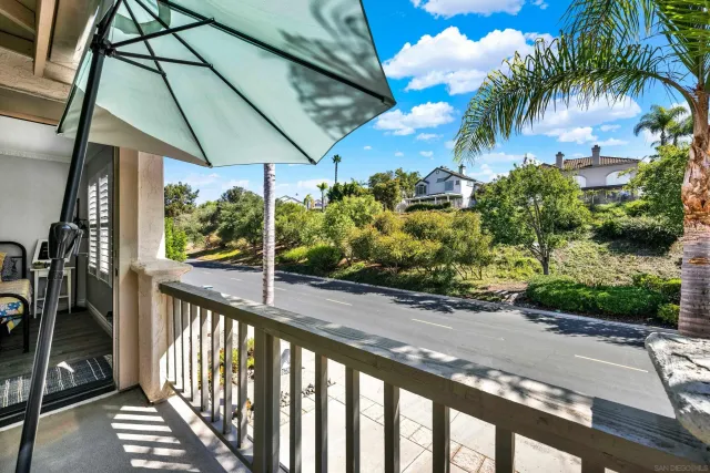 a view of a patio with table and chairs under an umbrella